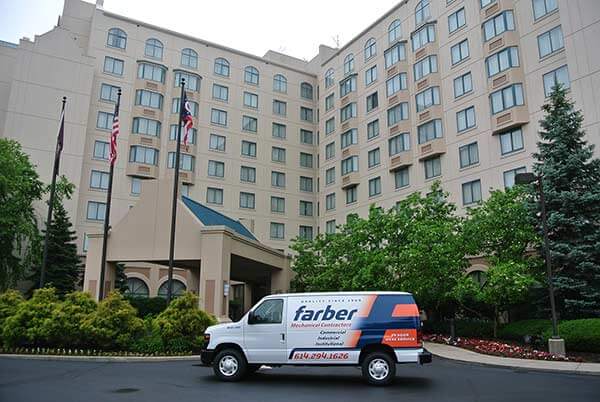 Farber Mechanical Contractors service van parked in front of a hotel